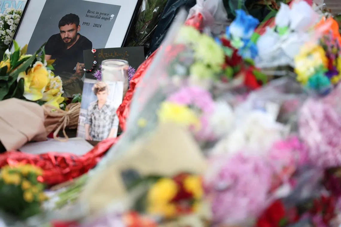 FILE PHOTO: Flowers and tributes to remember former One Direction singer Liam Payne, who was found dead after he fell from a third-floor hotel room balcony in Buenos Aires, are seen in a park in his home town of Wolverhampton, Britain, November 13, 2024. REUTERS/Phil Noble/File Photo