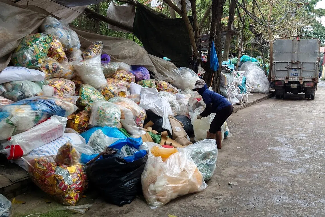 A woman sorts plastic waste at Minh Khai Craft Village in Hung Yen province, Vietnam, February 26, 2024. REUTERS/Khanh Vu
