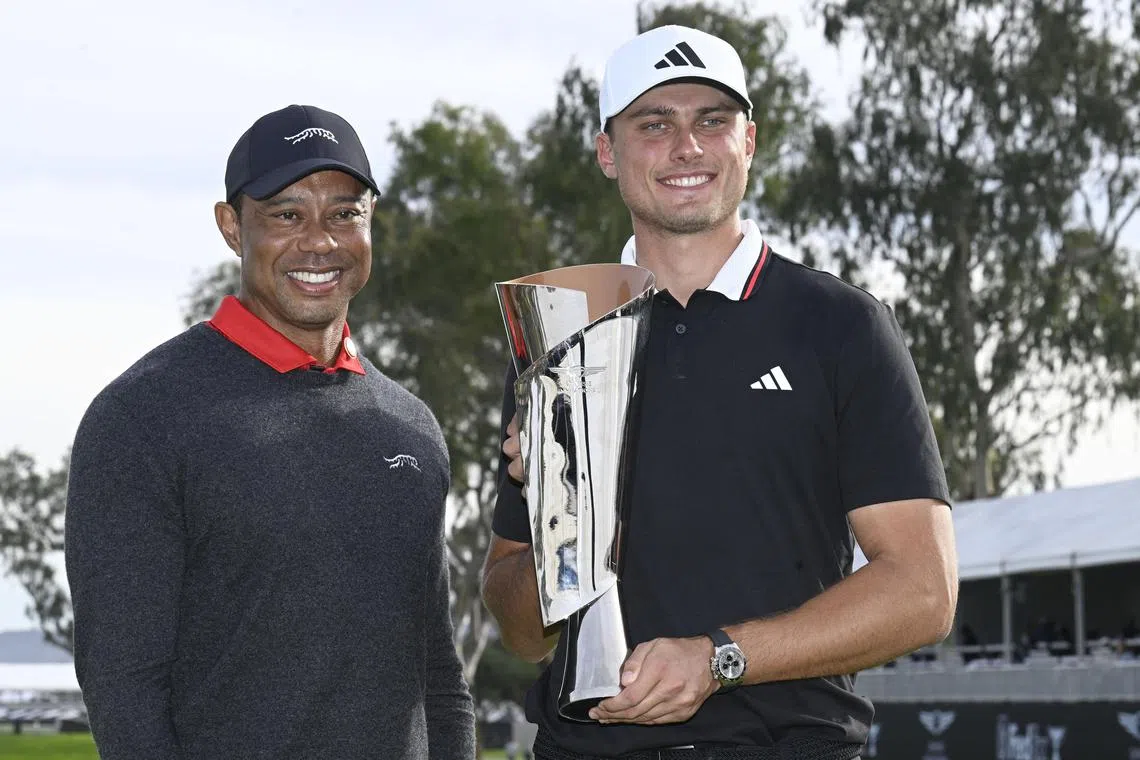 Ludvig Aberg holds the trophy next to Tiger Woods after winning The Genesis Invitational golf tournament at Torrey Pines in San Diego on Feb 16, 2025.