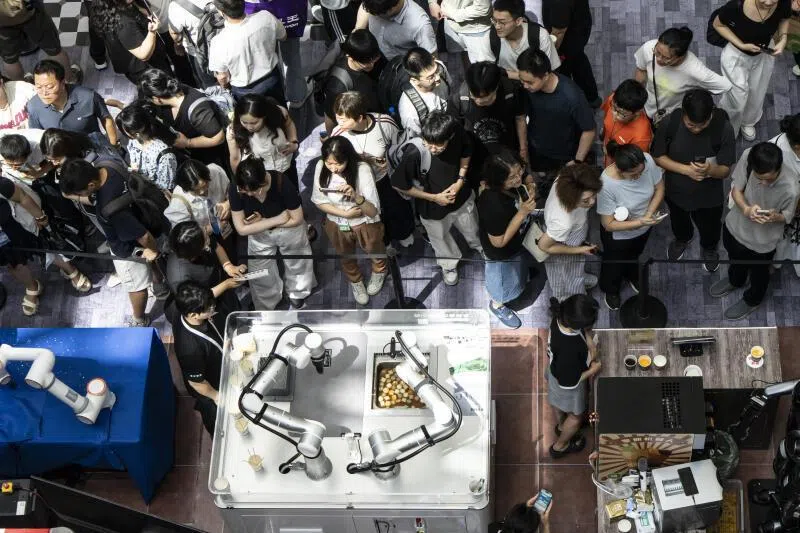In China, the AI threat isn't confined to white collar work. Service robots like this on display at the World Artificial Intelligence Conference in Shanghai last year also threaten the jobs of gig workers.