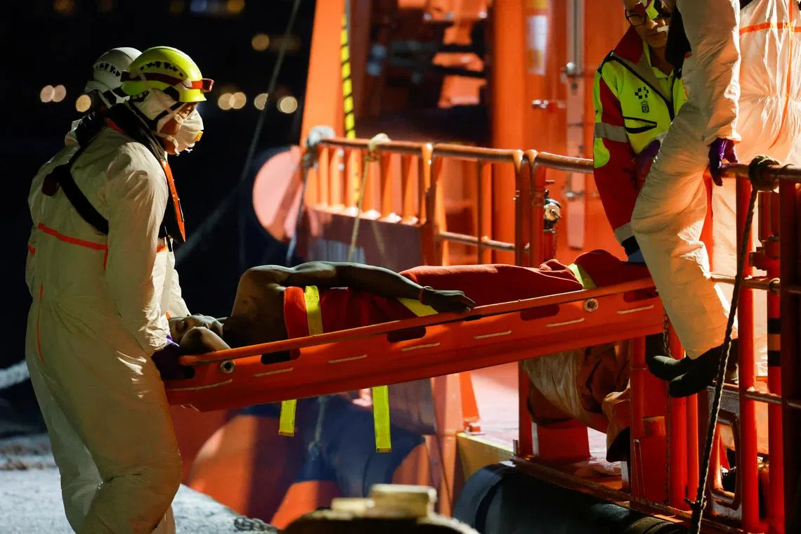 FILE PHOTO: Rescuers disembark a migrant in critical condition from a Spanish coast guard vessel at the port of Arguineguin, on the island of Gran Canaria, Spain, March 20, 2024. REUTERS/Borja Suarez/File Photo