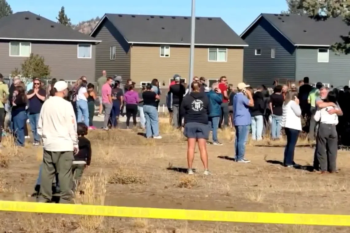 People stand near the scene of a shooting at Silver Rail Elementary School in Bend, Oregon, US, October 15, 2026, in this screengrab from a handout video.     ABC affiliate KOHD/Handout via REUTERS
