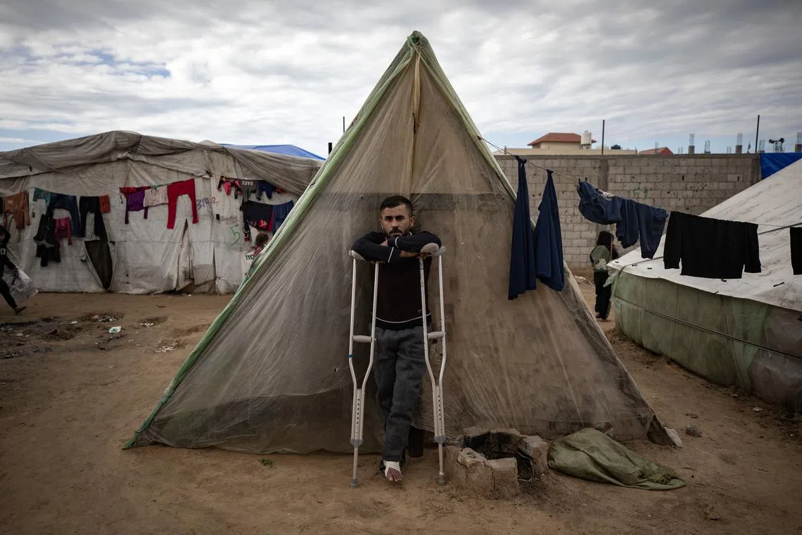 An injured Palestinian man outside his tent in the Rafah camp, southern Gaza Strip, on Feb 18, 2024. 