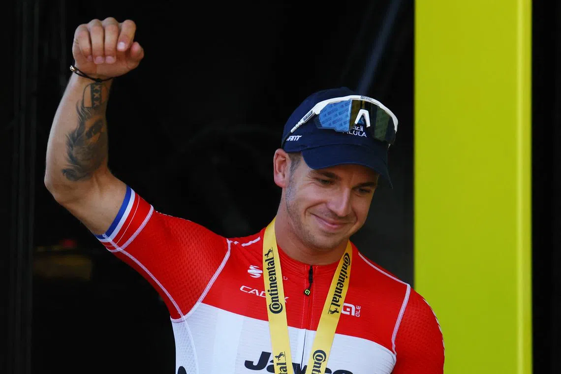Cycling - Tour de France - Stage 6 - Macon to Dijon - Macon, France - July 4, 2024 Team Jayco AlUla's Dylan Groenewegen celebrates on the podium after winning stage 6 REUTERS/Molly Darlington