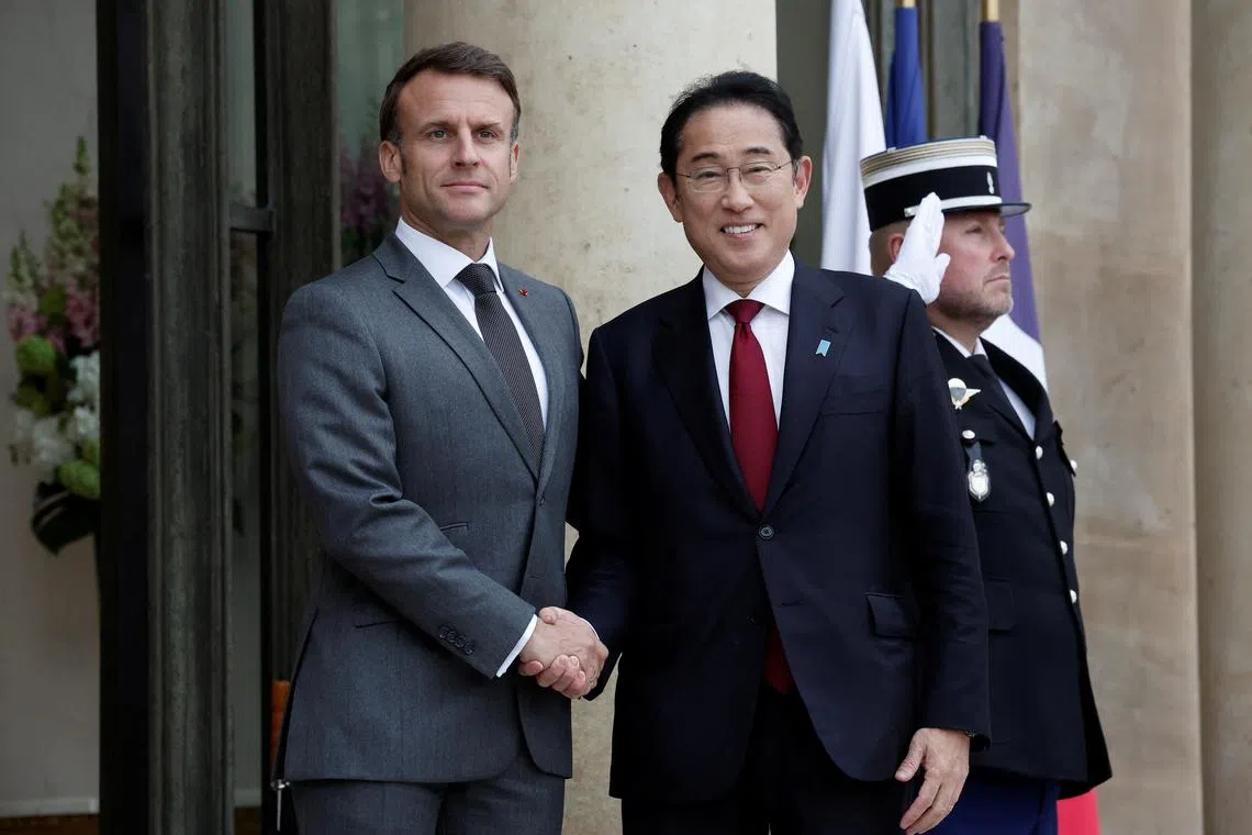 French President Emmanuel Macron welcomes Japan's Prime Minister Fumio Kishida as he arrives for a meeting at the Elysee Palace in Paris, France, May 2, 2024. REUTERS/Benoit Tessier