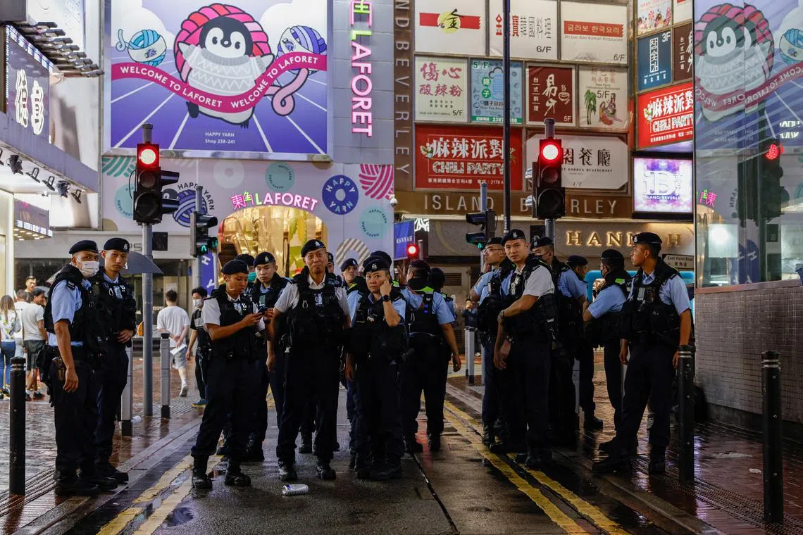 FILE PHOTO: Police stand guard at Causeway Bay, ahead of the 35th anniversary of the crackdown on pro-democracy demonstrators at Beijing's Tiananmen Square in 1989, near where the candlelight vigil is usually held, in Hong Kong, China, June 3, 2024. REUTERS/Tyrone Siu/File Photo