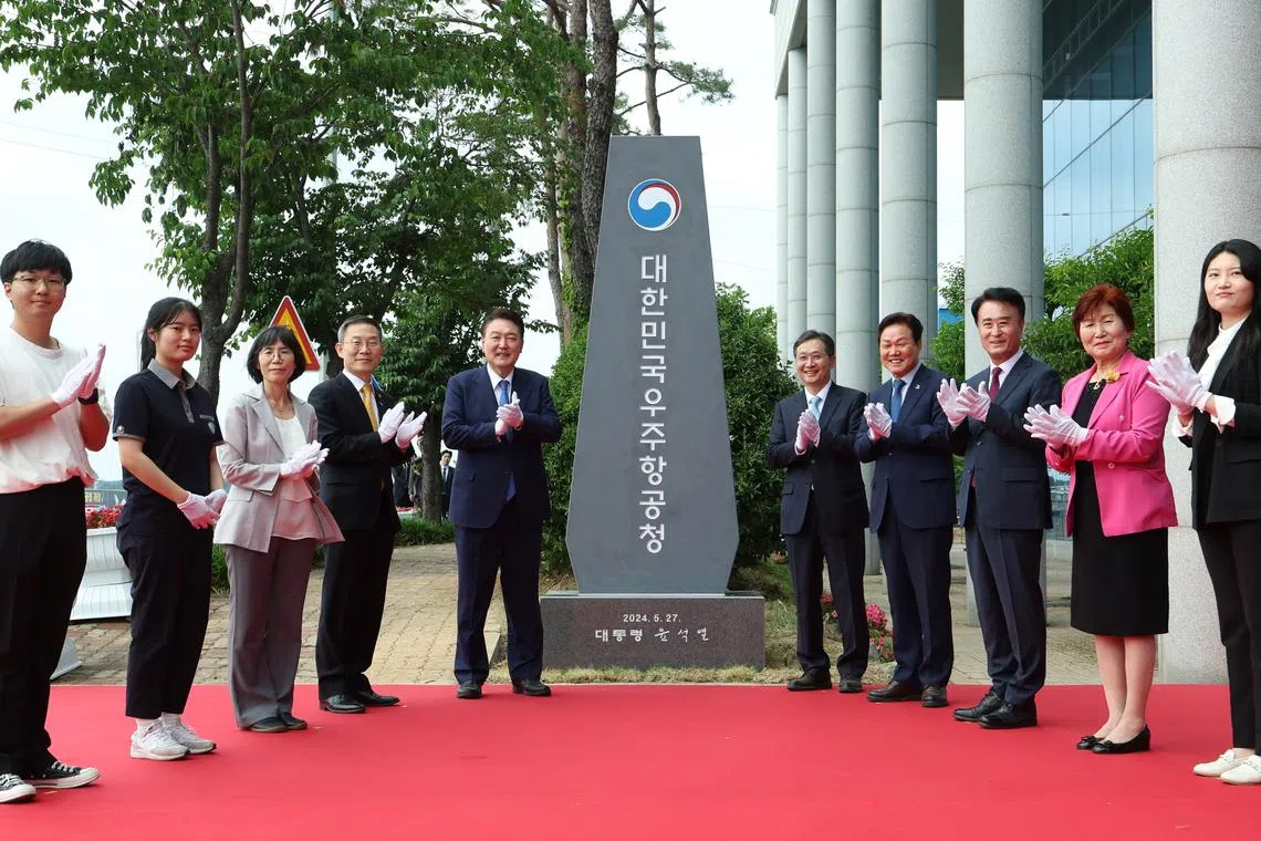 South Korean President Yoon Suk Yeol (fifth from left) and other participants during a ceremony unveiling the agency's stone sign.