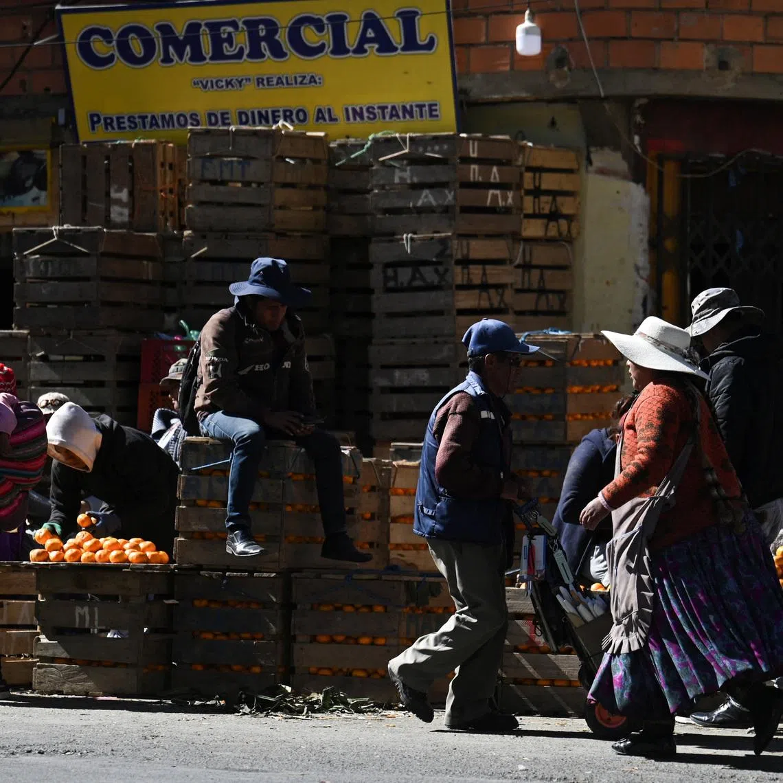 People visit a market to stock up on food and other supplies as Bolivia's crisis begins to ease after lawmakers backed the state of emergency, in El Alto, Bolivia, June 21, 2026. REUTERS/Claudia Morales