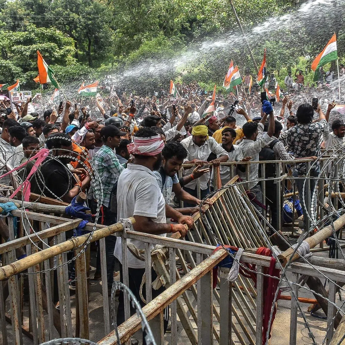 Police personnel use water cannon to disperse demonstrators during an ongoing protest against alleged irregularities in the Jharkhand Public Service Commission and Jharkhand Staff Selection Commission recruitment exams.