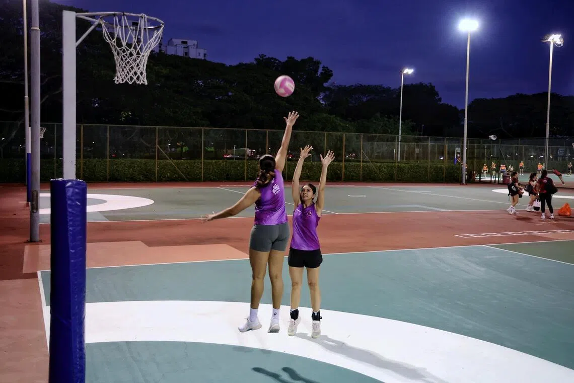 Goal shooter Amandeep Kaur from Sneakers attempting a shot over teammate and goal keeper Reena Divya from the super shot zone at Kallang Netball Centre on Feb 10, 2026.