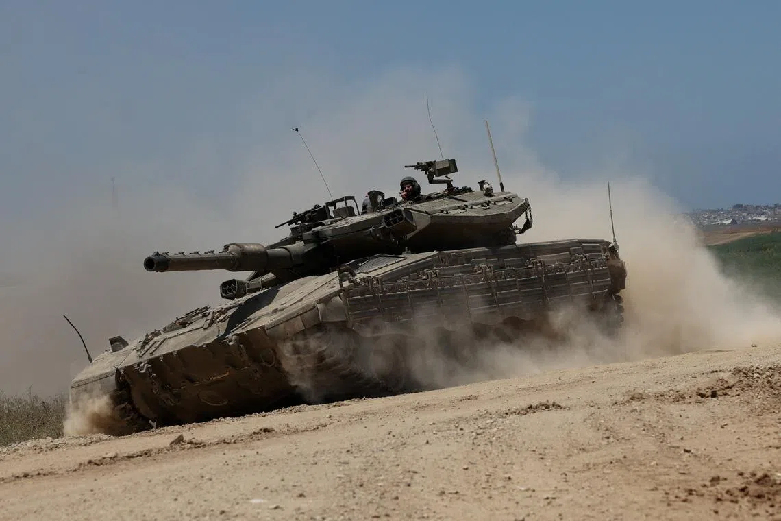 An Israeli tank manoeuvres near the Israel-Gaza border, amid the ongoing conflict between Israel and the Palestinian Islamist group Hamas, in Israel, May 16, 2024. REUTERS/Shannon Stapleton