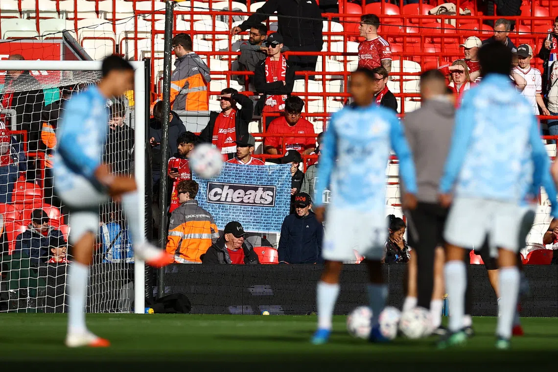 Liverpool fans display a banner ahead of their Premier League clash against Manchester United on Oct 11, amid ongoing Premier League charges against the club.