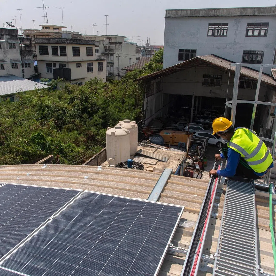 A worker installing solar panels at a factory in Nakhon Pathom province in Thailand.