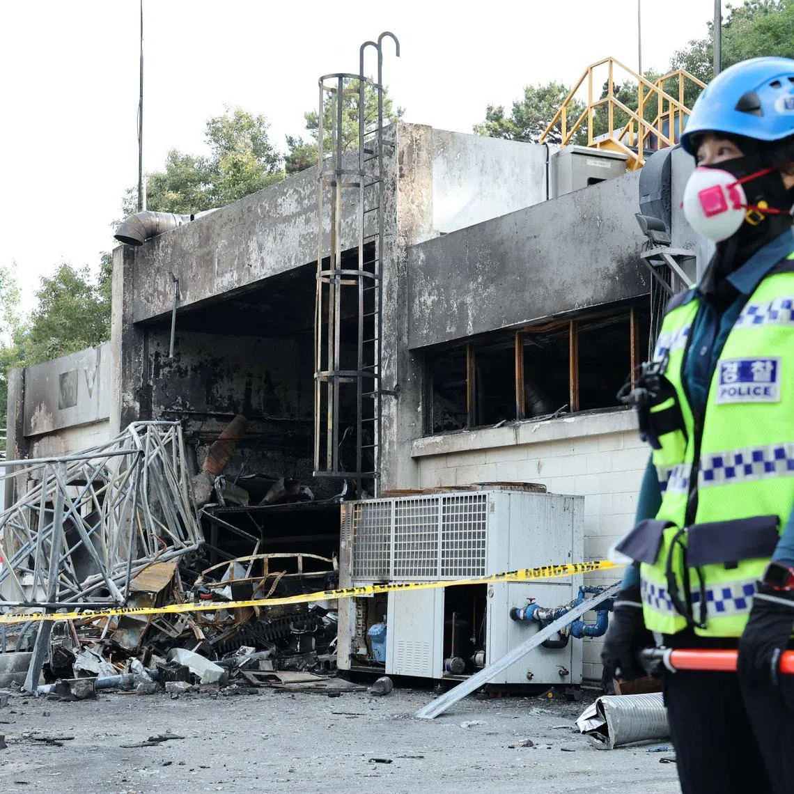 A police officer stands in front of heavily damaged production line for rocket propellant of Hanwha Aerospace's factory after an explosion, in Daejeon, South Korea, June 1, 2026.    Yonhap via REUTERS