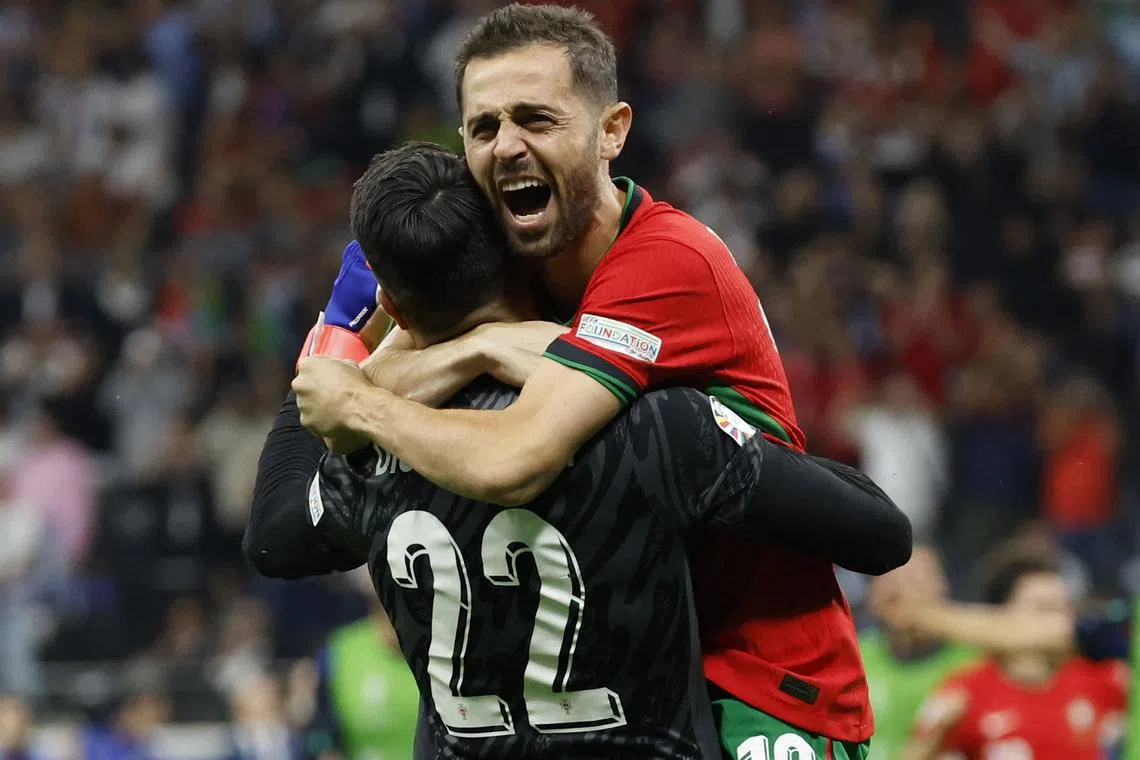 Soccer Football - Euro 2024 - Round of 16 - Portugal v Slovenia - Frankfurt Arena, Frankfurt, Germany - July 1, 2024  Portugal's Bernardo Silva celebrates with Diogo Costa after scoring the winning penalty during the penalty shootout REUTERS/Heiko Becker