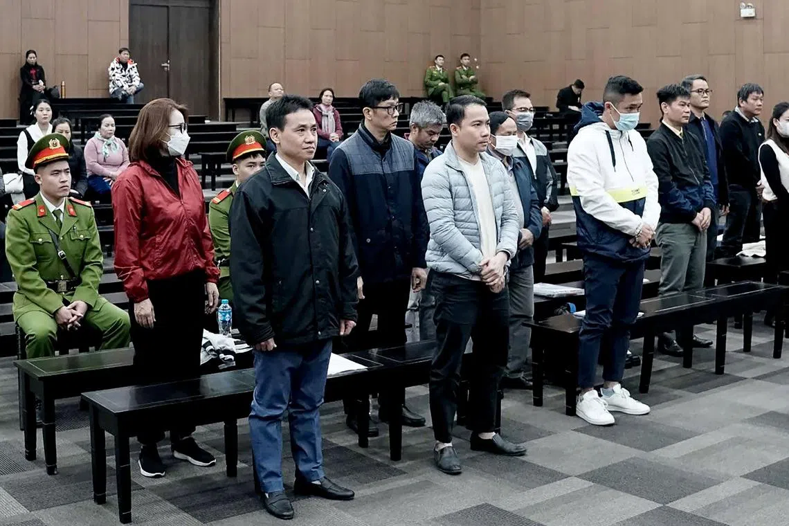 Vietnamese officials accused of corruption over repatriation flights at the start of the Covid-19 pandemic stand during their trial at the Hanoi People's Court in Hanoi on Dec 24, 2024.