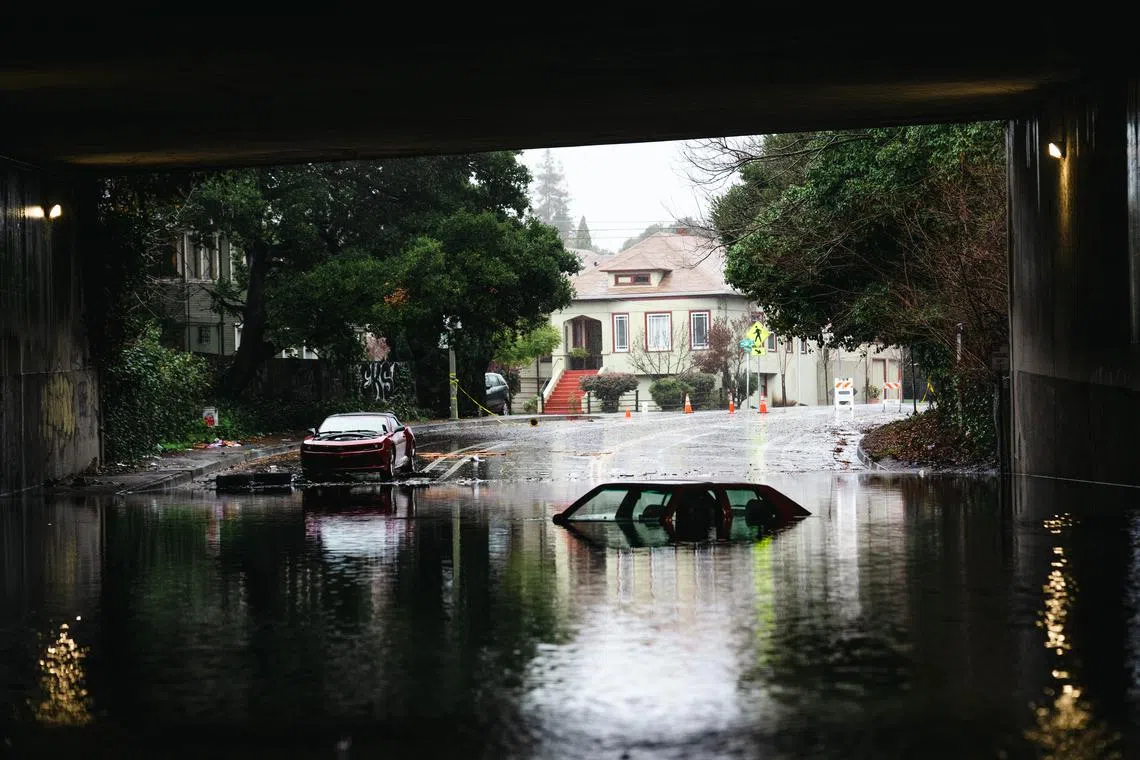 Cars stuck under an overpass in Oakland, California, Jan. 5, 2023. 