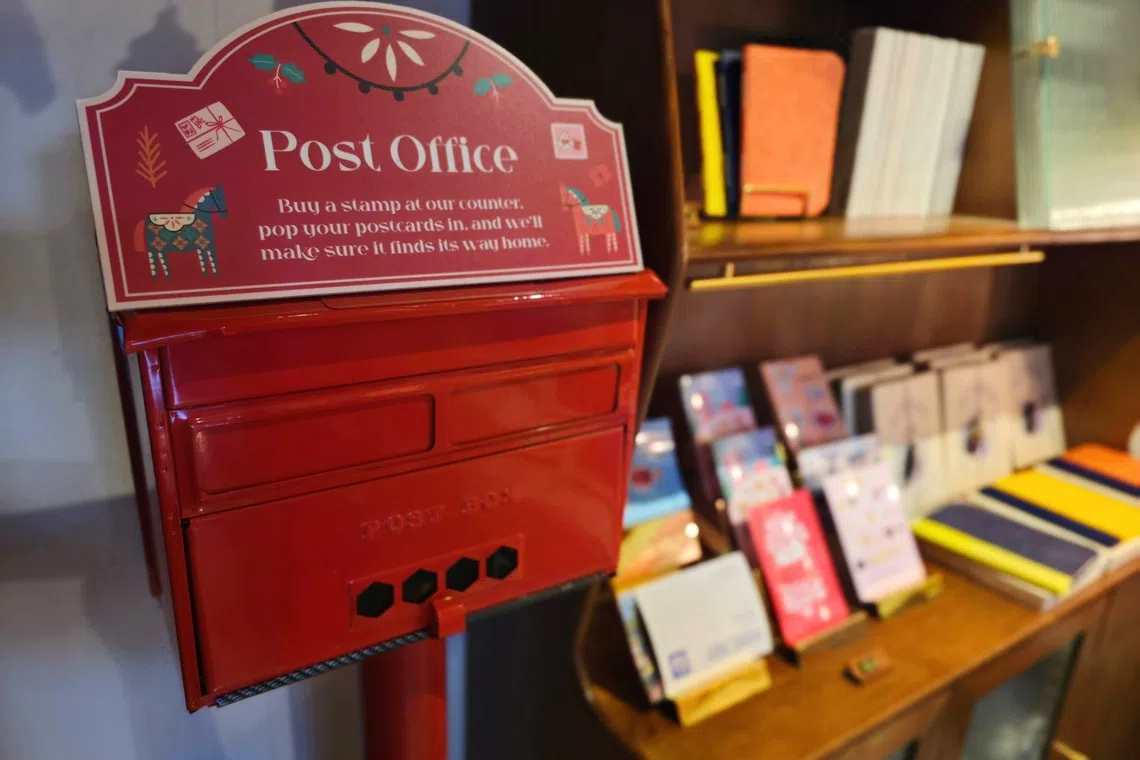 A retro post box sits beside a row of postcards at Books Beyond Borders’ bookshop just across the Maxwell MRT station.
