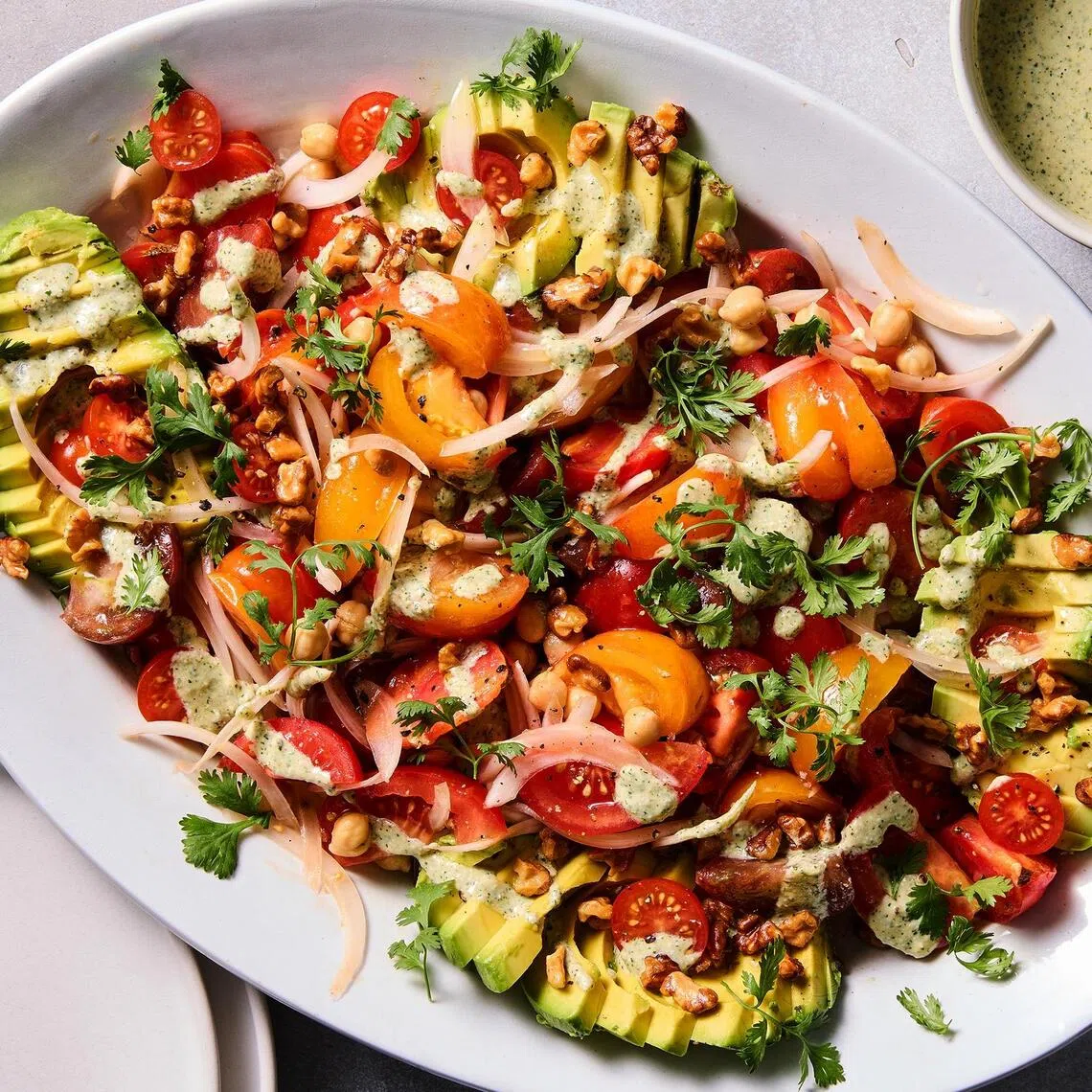 Tomato avocado salad with creamy feta dressing.