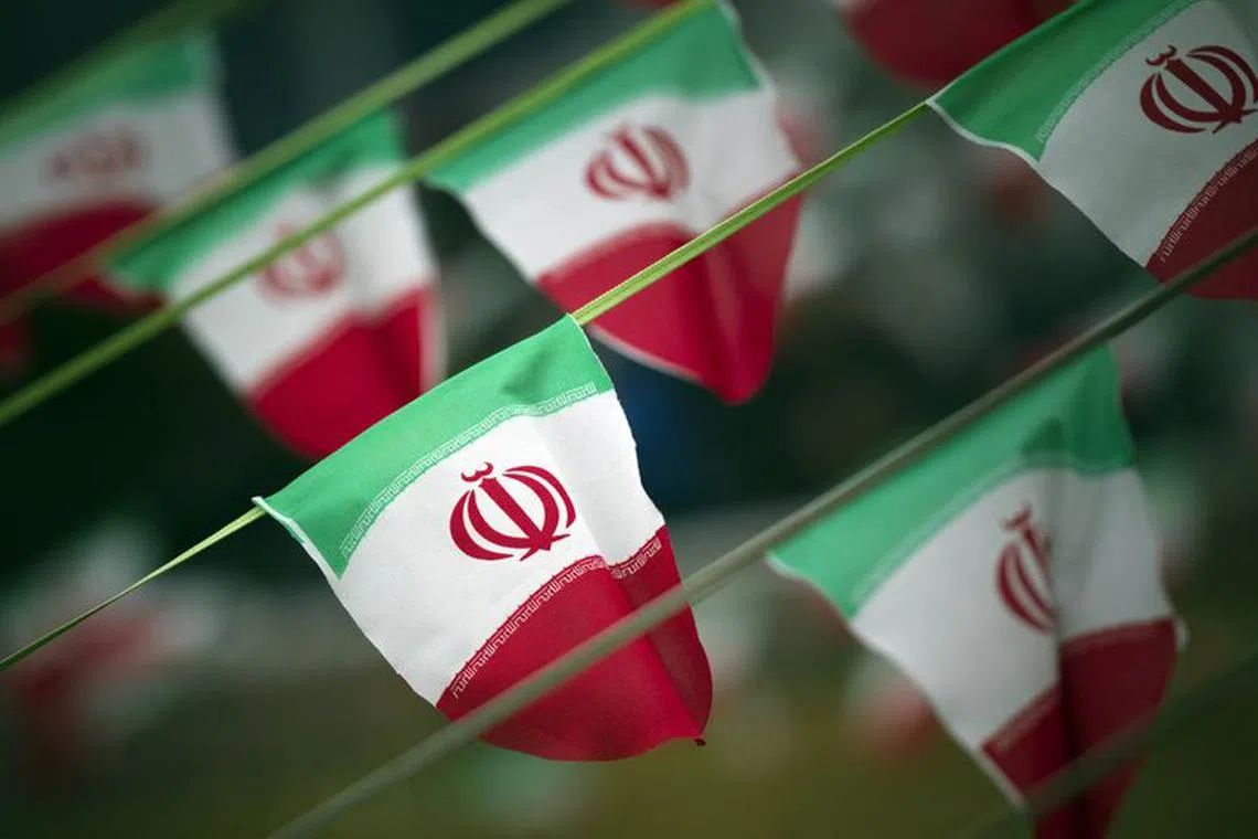 Iran's national flags are seen on a square in Tehran February 10, 2012. REUTERS/Morteza Nikoubazl/File Photo