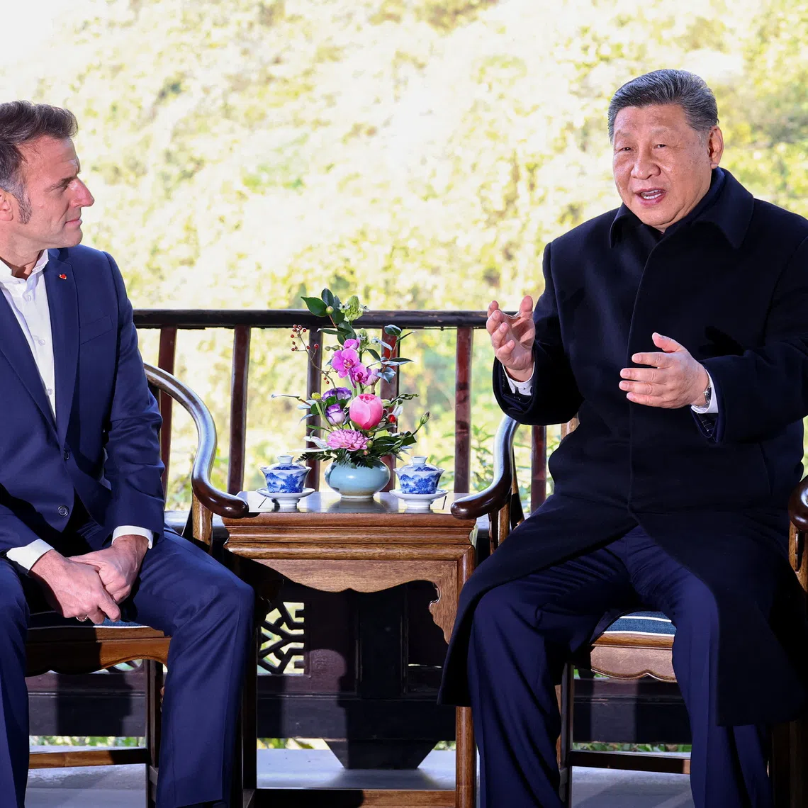 French President Emmanuel Macron and Chinese President Xi Jinping speak during a visit to the Dujiangyan site, designated a UNESCO World Heritage Site, in Dujiangyan, Sichuan province, as part of Macron's three-day visit to China, December 5, 2025. REUTERS/Sarah Meyssonnier/Pool