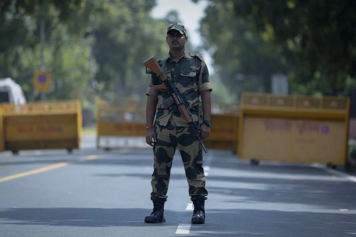 A paramilitary soldier stands guard outside Le Meridien hotel during a rehearsal ahead of the G20 Summit in New Delhi, India, September 2, 2023. REUTERS/Adnan Abidi/File Photo