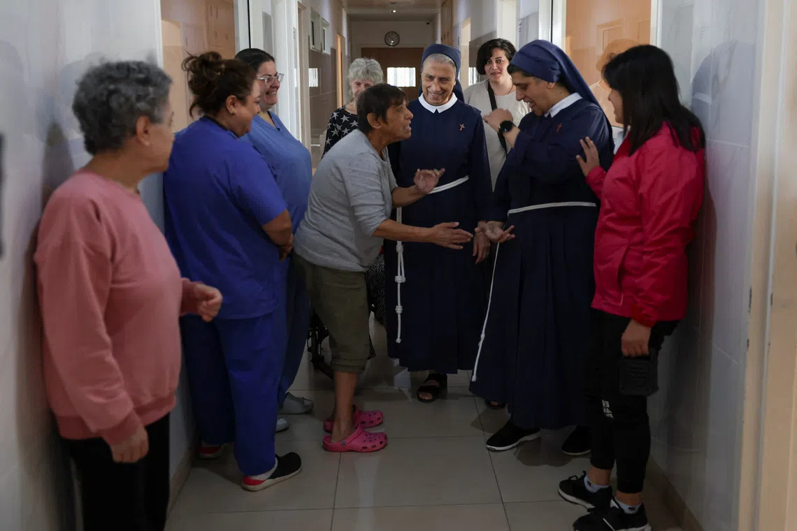 General superior of the congregation of the franciscan sisters of the cross, Mother Marie Makhlouf and Director of De La Croix Psychiatric Hospital, sister Rose Hanna, talk with patients at the hospital in Jal el-Dib, Lebanon November 19, 2025. REUTERS/Mohamed Azakir