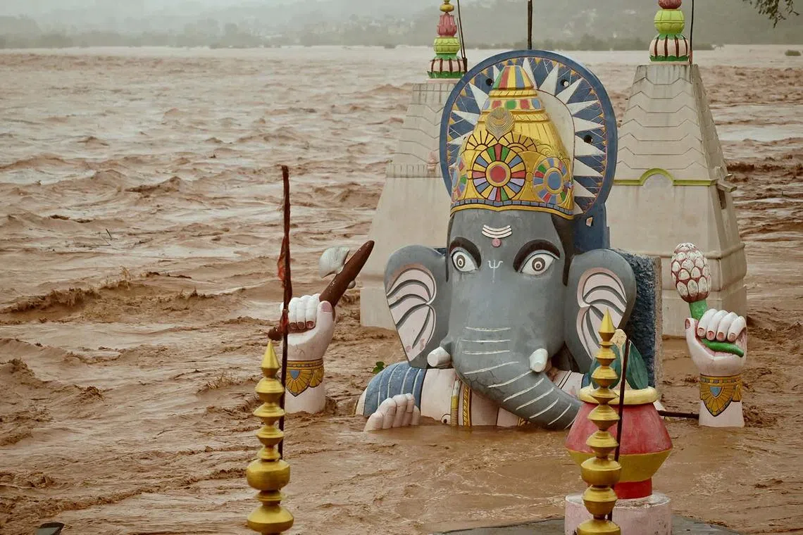 Water from the overflowing Tawi River floods a temple of the Hindu elephant god Ganesh, the deity of prosperity, following heavy rain in Jammu, Indian Kashmir, Aug 26, 2025. 