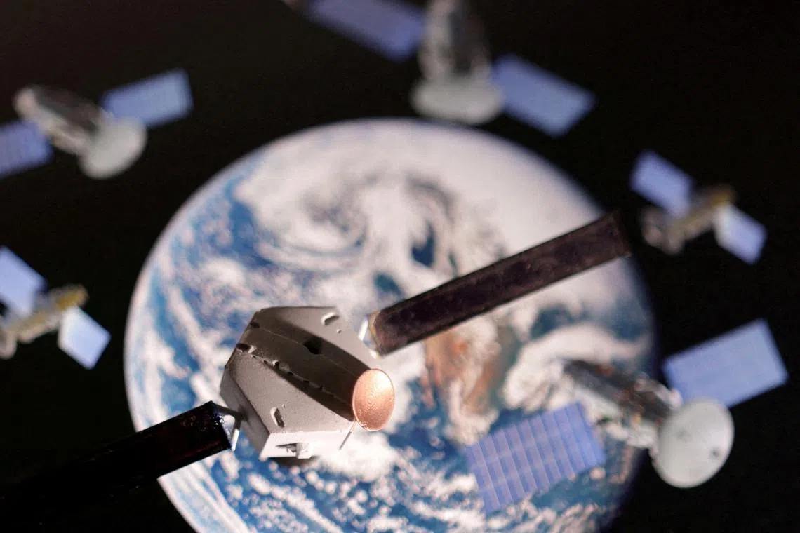 FILE PHOTO: A satellite model is placed on a picture of Earth in this illustration taken November 25, 2024. REUTERS/Dado Ruvic/Illustration/File Photo