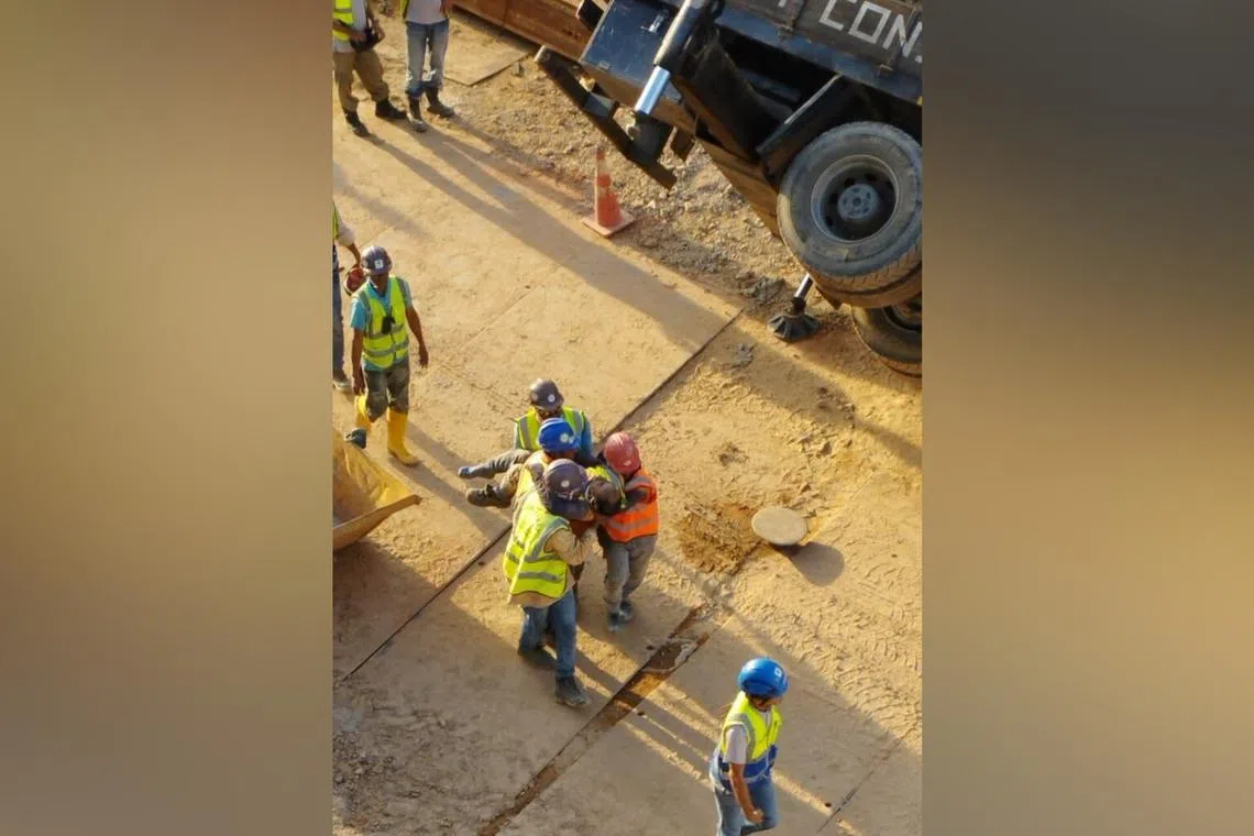 The worker was struck by a concrete bucket, fracturing his ankle and cutting his hand.