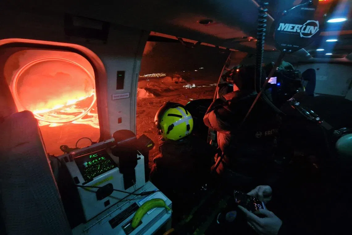 A cameraman filming the lava flow from a new volcanic eruption on Feb 8, 2024 in Grindavik, western Iceland. 