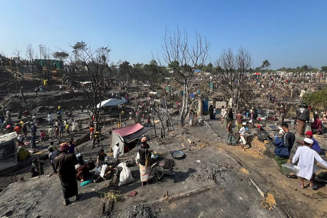 Rohingya refugees work on rebuilding their makeshift shelters after a fire broke out in a camp in Cox's Bazar, Bangladesh, January 7, 2024. REUTERS/Ro Yassin Abdumonab