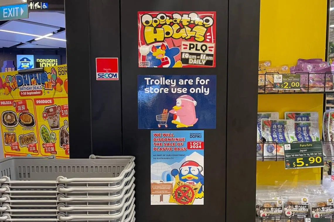 A sign outside Don Don Donki's Paya Lebar Square outlet says it will discontinue the sale of plastic bags from Oct 1.