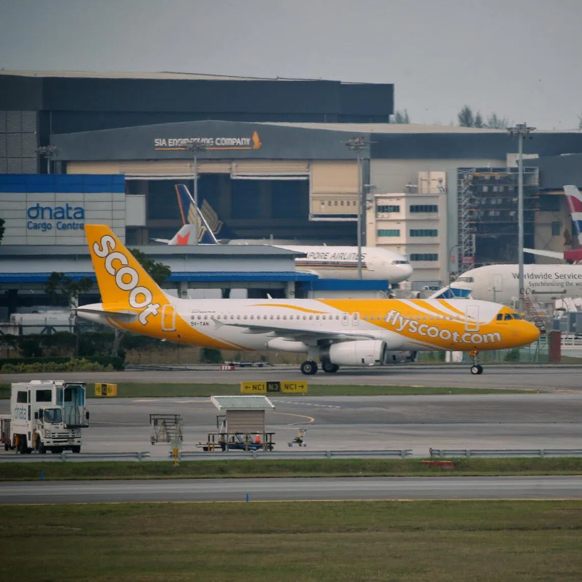 A Scoot Airbus A320 passenger plane on the tarmac of Changi Airport.