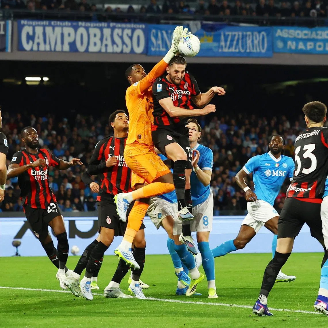 FILE PHOTO: Soccer Football - Serie A - Napoli v AC Milan - Stadio Diego Armando Maradona, Naples, Italy - April 6, 2026 AC Milan's Mike Maignan in action with Napoli's Scott McTominay and AC Milan's Adrien Rabiot. REUTERS/Ciro De Luca/File Photo