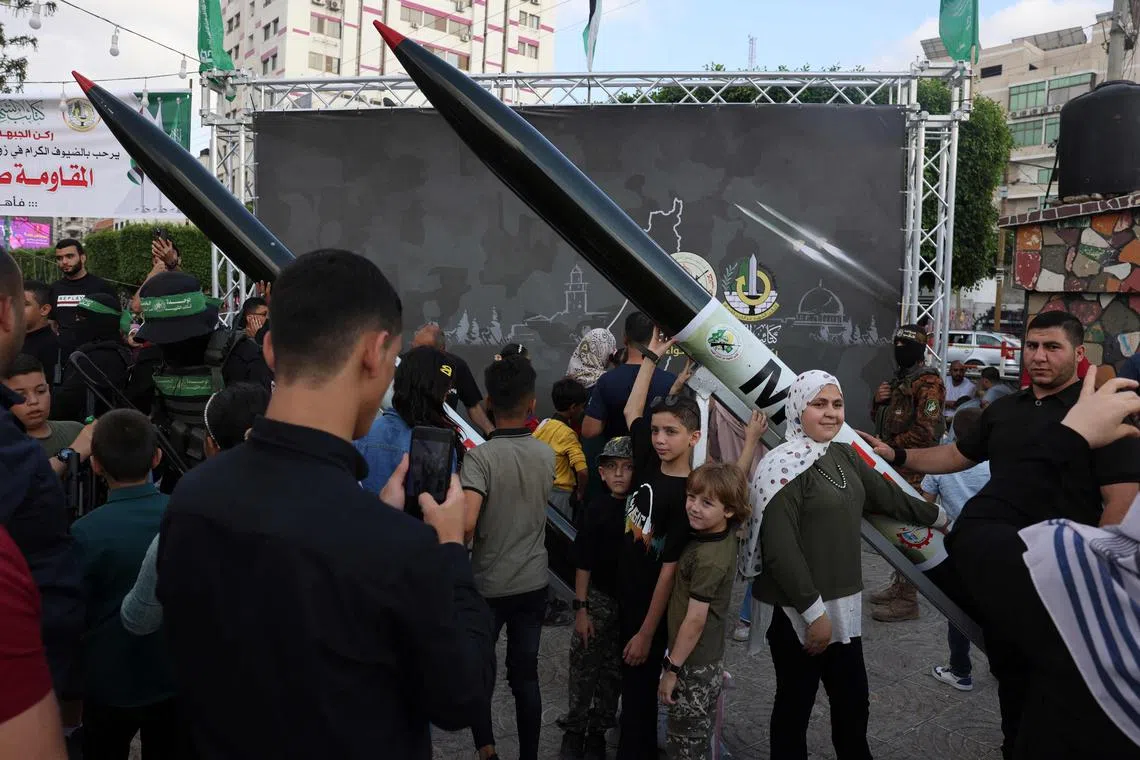 A Palestinian poses for a souvenir picture with an RPG launcher.