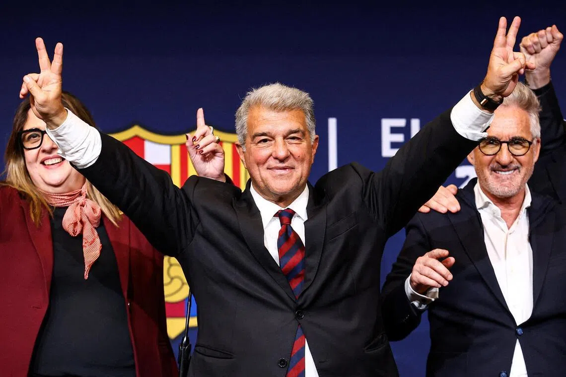 Joan Laporta celebrates his victory after being re-elected as Barcelona president alongside his board members.