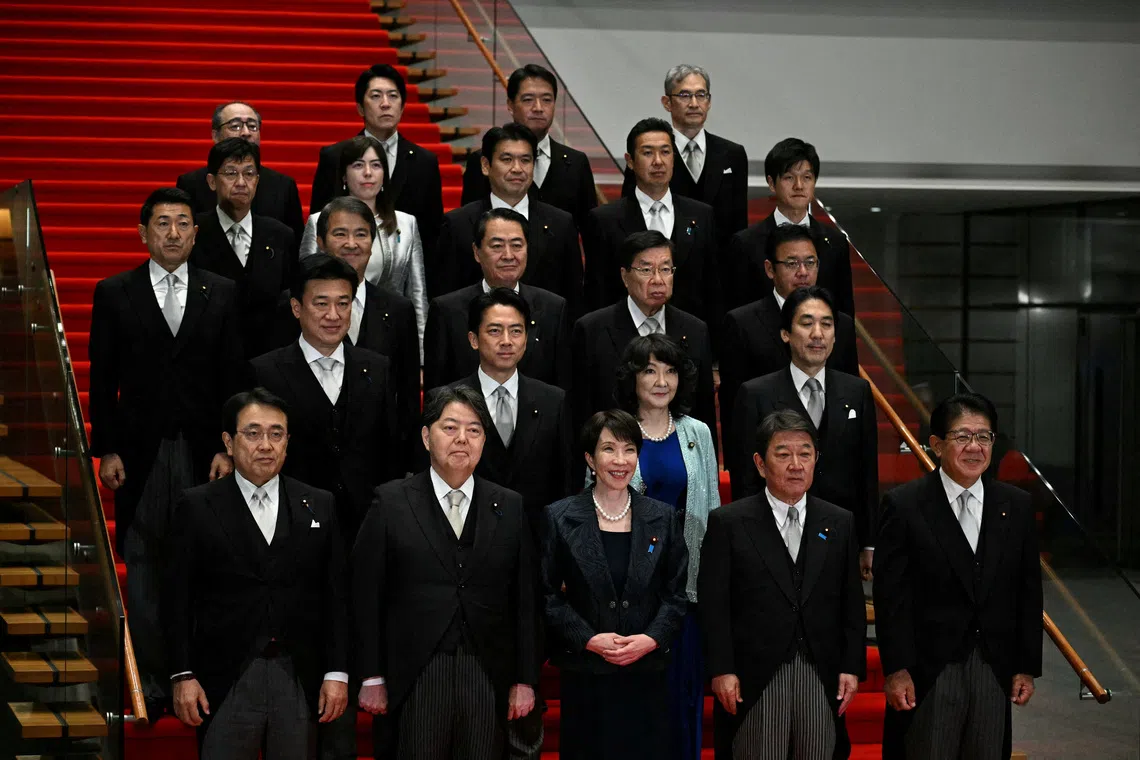 Japan's new Prime Minister Sanae Takaichi (C, first row) poses during a photo session with members of her cabinet at the prime minister's office in Tokyo, Japan October 21, 2025.     PHILIP FONG/Pool via REUTERS   REFILE - CORRECTING LOCATION FROM \"PRIME MINISTER'S OFFICIAL RESIDENCE\" TO \"PRIME MINISTER'S OFFICE\".