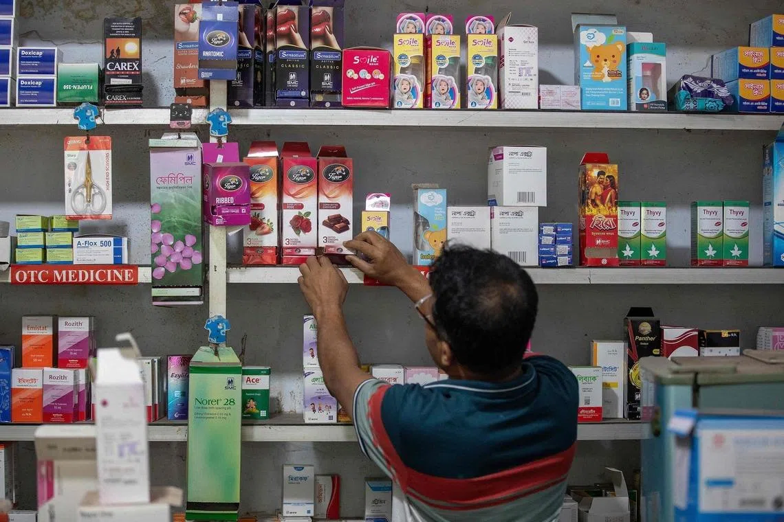 A worker arranging packets of condoms at a pharmacy in Dhaka, Bangladesh, on April 27. Government clinics across the country of 170 million people running out of basic contraceptives.