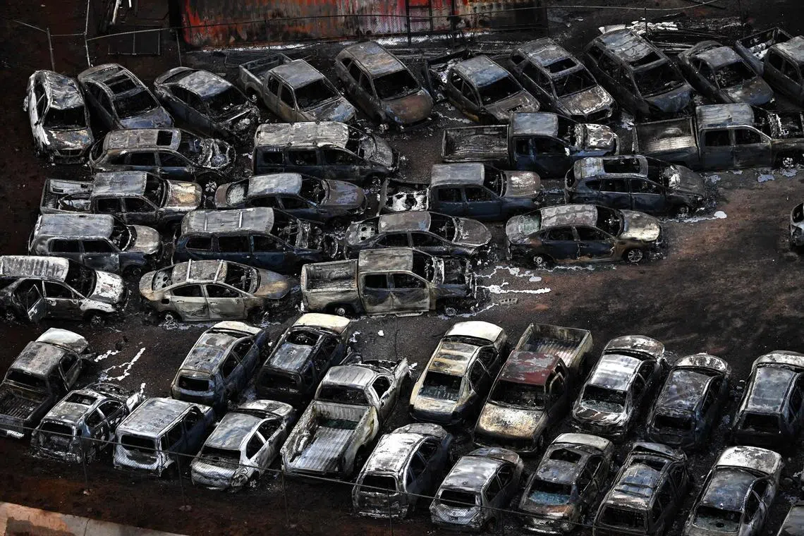 Cars destroyed by wildfires are seen in Lahaina on Aug 10, 2023. 