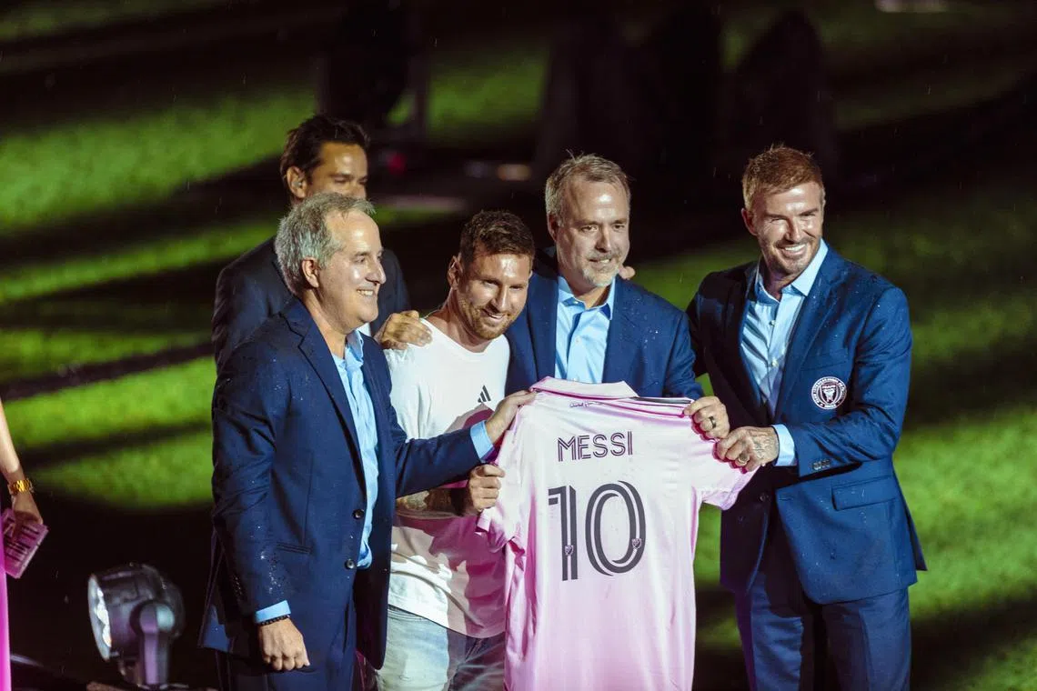 Lionel Messi and Inter Miami co-owners, from left: Jorge Mas, Jose Mas and England and Manchester United legend David Beckham with the iconic pink jersey.