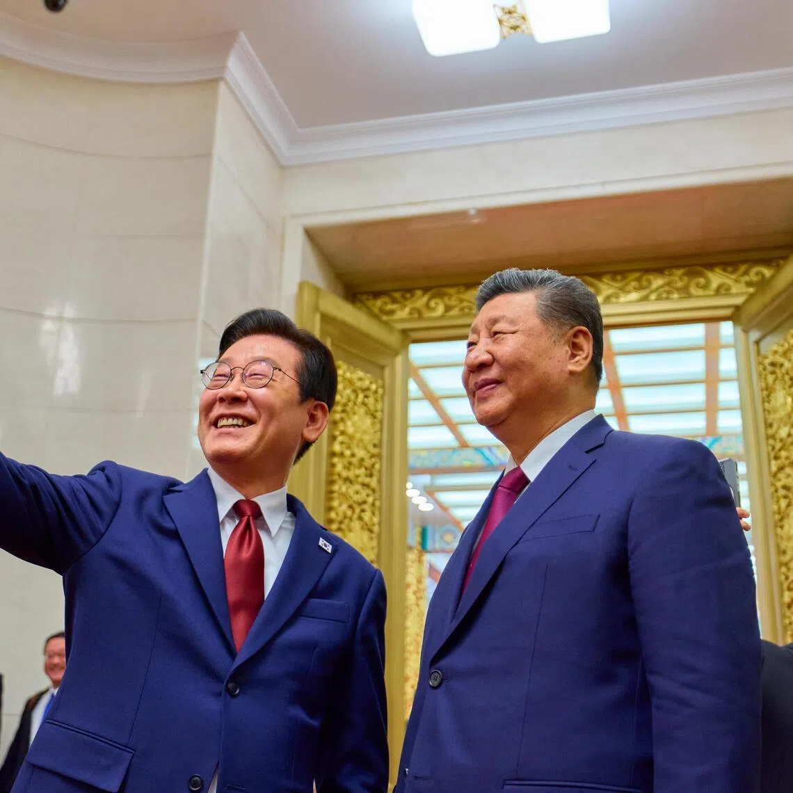 South Korean President Lee Jae Myung (left) takes a selfie with Chinese President Xi Jinping with a Xiaomi smartphone after a state dinner in Beijing on Jan 5.