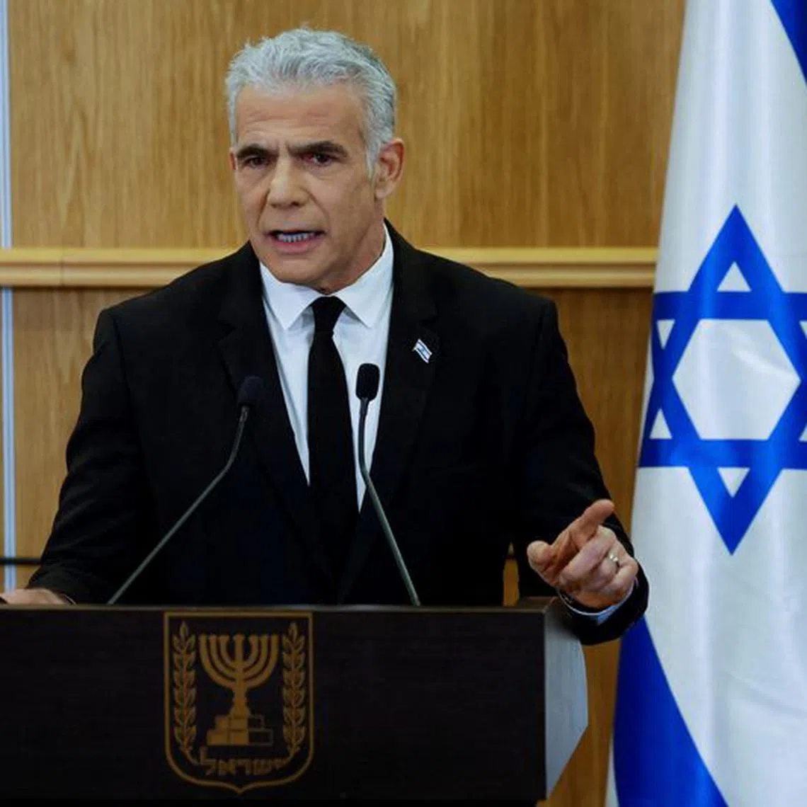 FILE PHOTO: Israeli opposition leader Yair Lapid delivers a statement at the Knesset, Israel's parliament, on the day Israel's constitution committee is set to start voting on changes that would give politicians more power on selecting judges while limiting Supreme Court powers to strike down legislation, in Jerusalem, February 13, 2023. REUTERS/Amir Cohen/File Photo