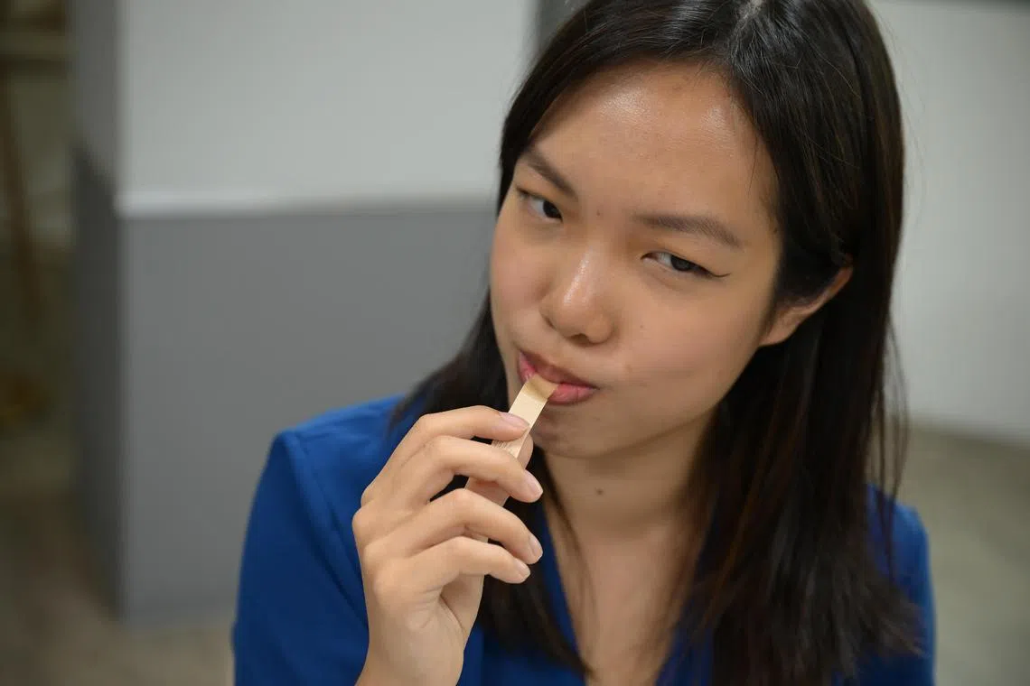 ST Reporter Cherie Lok tasted six strips dipped in solutions with different concentrations of salt to determine her threshold for saltiness. She could detect salt from the fourth strip onwards. 