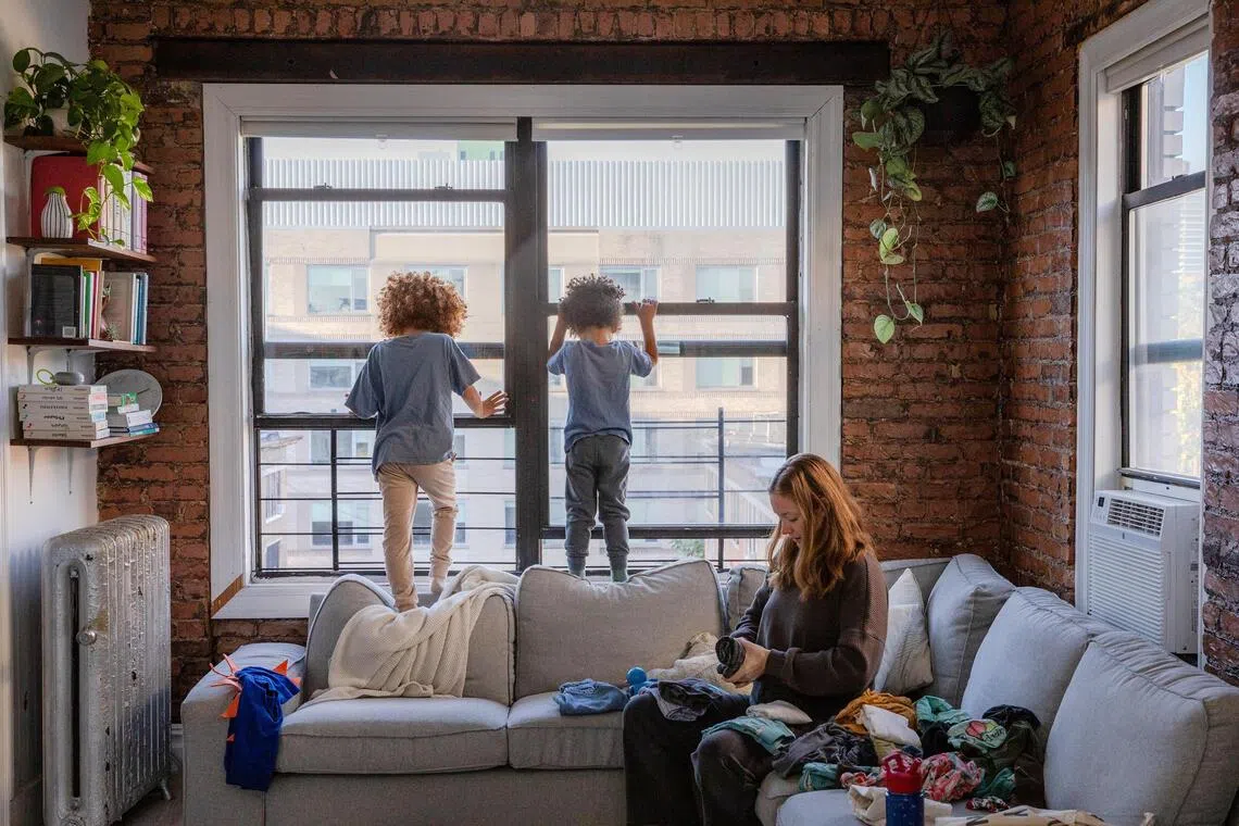 Sarah Almodovar lives with her husband and their three young children in a nearly 750-square-foot apartment in Washington Heights, N.Y., Oct. 3, 2025. The number of city households with three or more children has dropped by nearly 17 percent over the past decade as families struggle with the cost of child care and rent. (Natalie Keyssar/The New York Times)