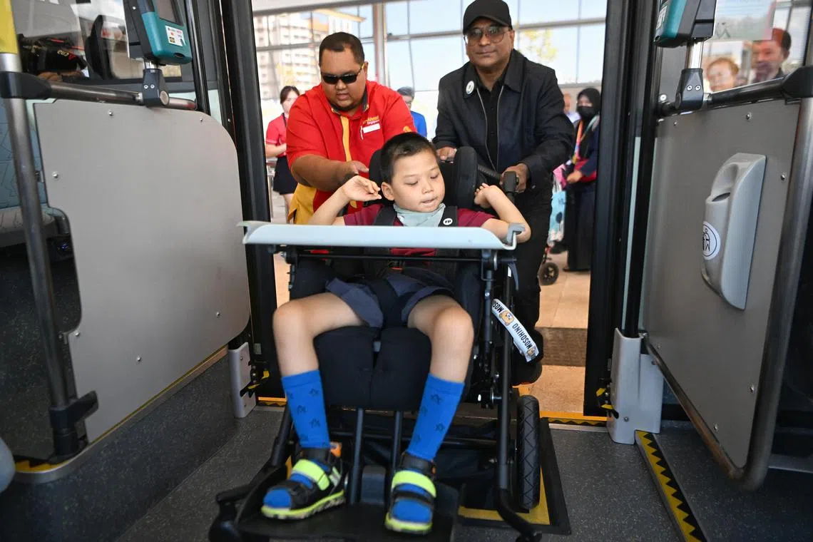 (In red) Go-Ahead Singapore Bus Captain, Muhd Burhan Saputra, 30, helping a student from Cerebral Palsy Alliance Singapore School (CPASS) board the bus at Tampines North Bus Interchange on May 12, 2023.



/The Helping Hand Scheme is one of the initiatives by the Caring SG Commuters Committee to foster a more caring, welcoming and inclusive public transport system. This scheme will be expanded to help other groups of commuters with mobility needs. Guest-of-Honour Senior Minister of State for Finance and Transport, Mr Chee Hong Tat and special guest Senior Parliamentary Secretary, Ministry of Sustainability and the Environment & Ministry of Transport, Mr Baey Yam Keng will be gracing an event to mark the launch of the expanded initiative.