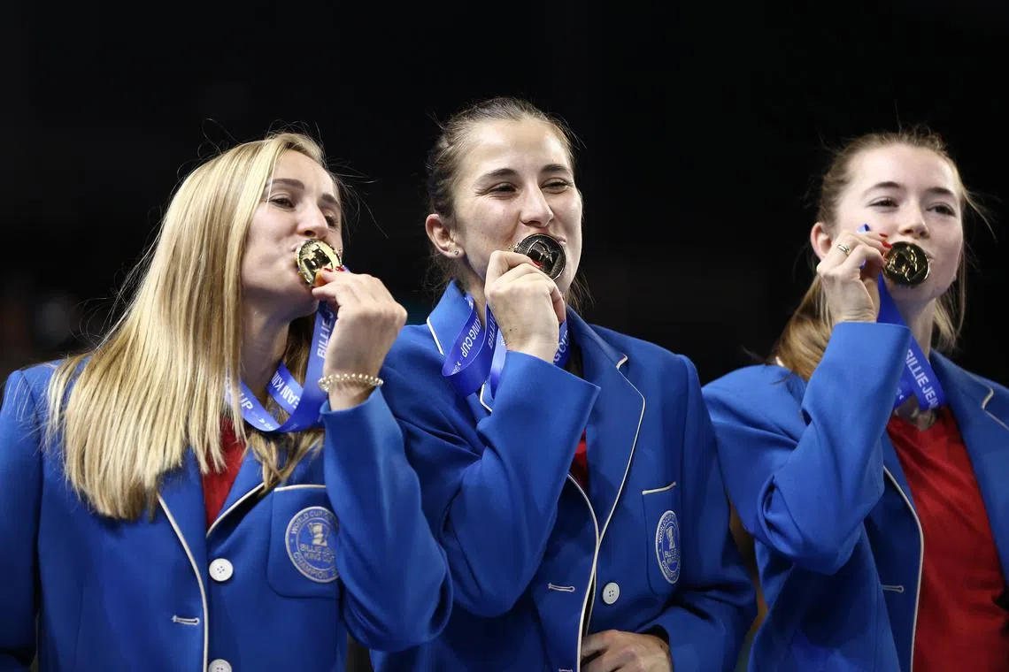 From left: Jil Teichmann, Belinda Bencic and Simon Waltert of Switzerland celebrating with their medals after becoming 2022 world Champions at the Billie Jean King Cup Finals in Glasgow on Sunday.