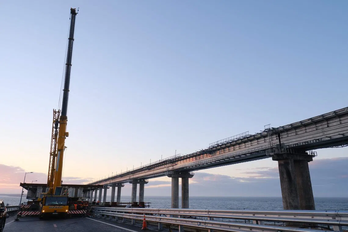 Restoration works on Jan 10 on damaged parts of the Kerch Bridge that links Crimea to Russia, which was hit by a blast in October. 