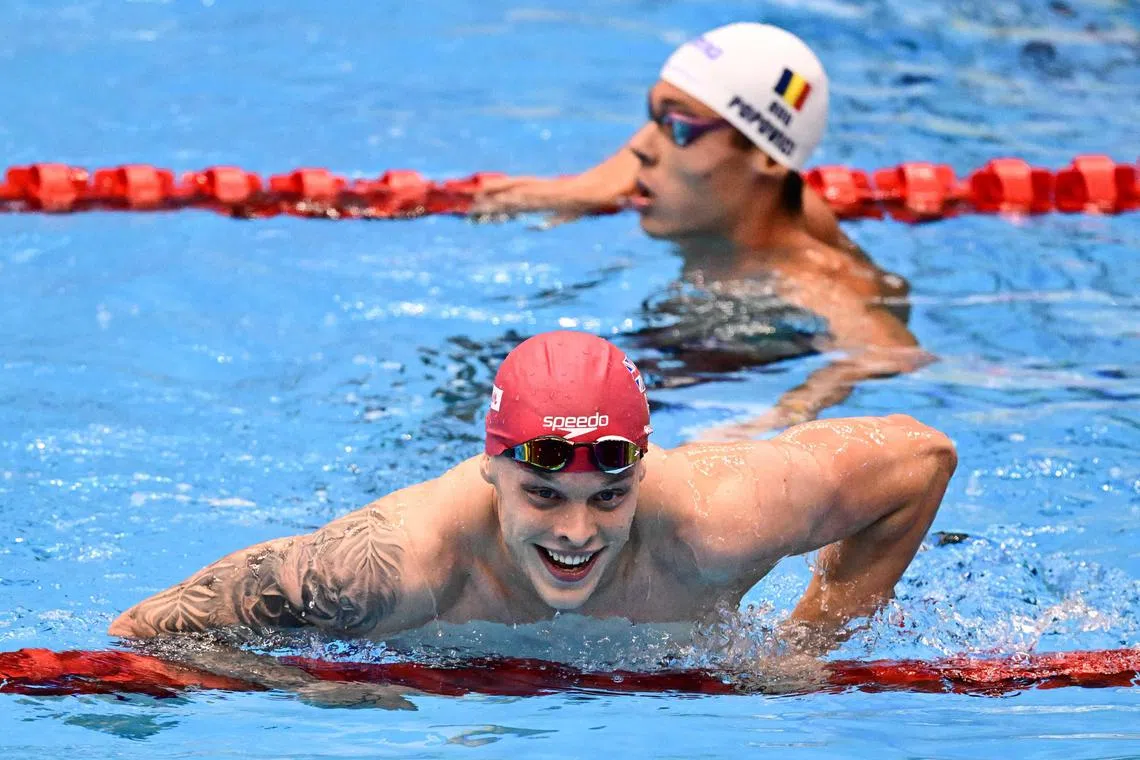 Britain's Matthew Richards (front) leaves the pool next to Romania's David Popovici after his victory in the men's 200m freestyle final.