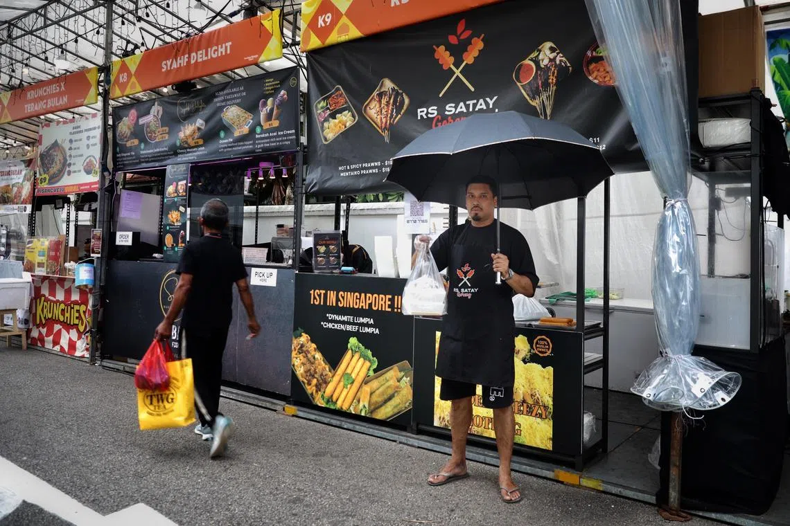 ST20250318_202581200514/zlmonsoon18/Taryn Ng/Zachary Lim Junpeng//

Mr Johari Bin Abdul Ghani, 40, a staff at RS Satay pictured at the stall at Kampong Glam Ramadan Bazaar on March 18, 2025. As the path for customers is unsheltered, he sometimes delivers food to customers who wait in the shelter when it rains. ST PHOTO: TARYN NG